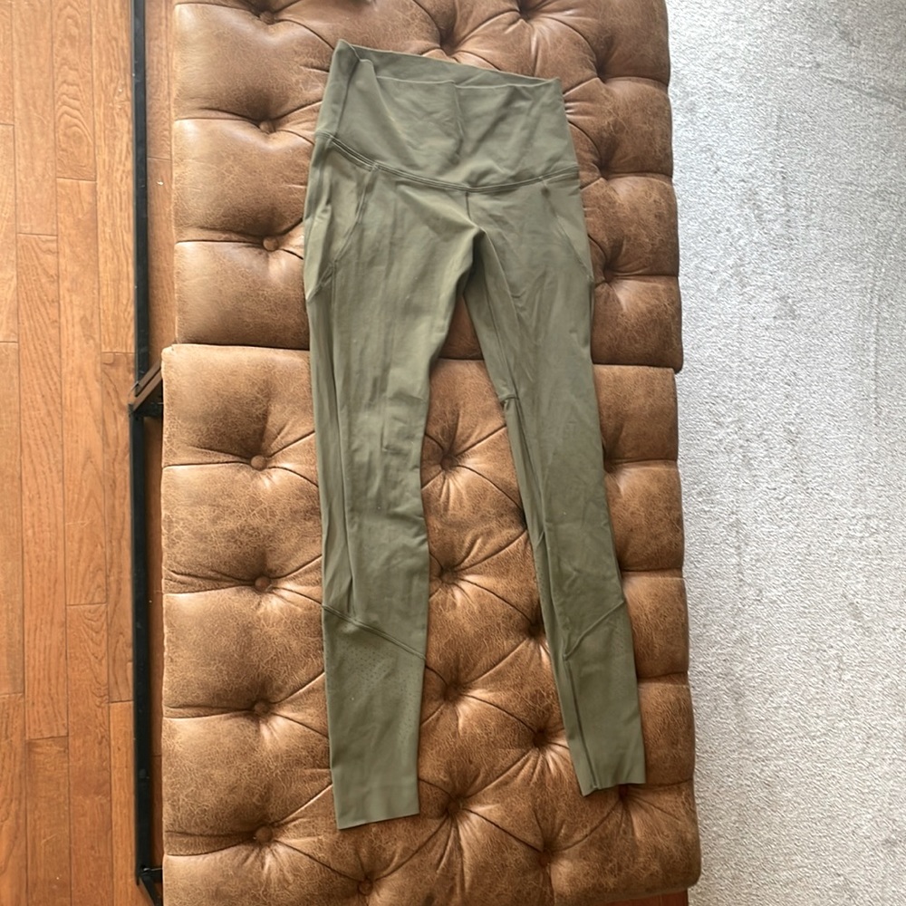 Olive green lululemon leggings. Size 8 with mesh detailing.